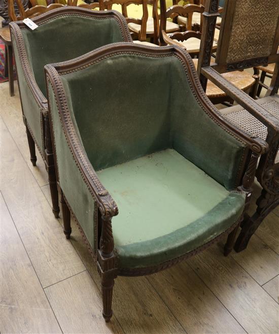 A pair of walnut and mahogany green upholstered fauteuils